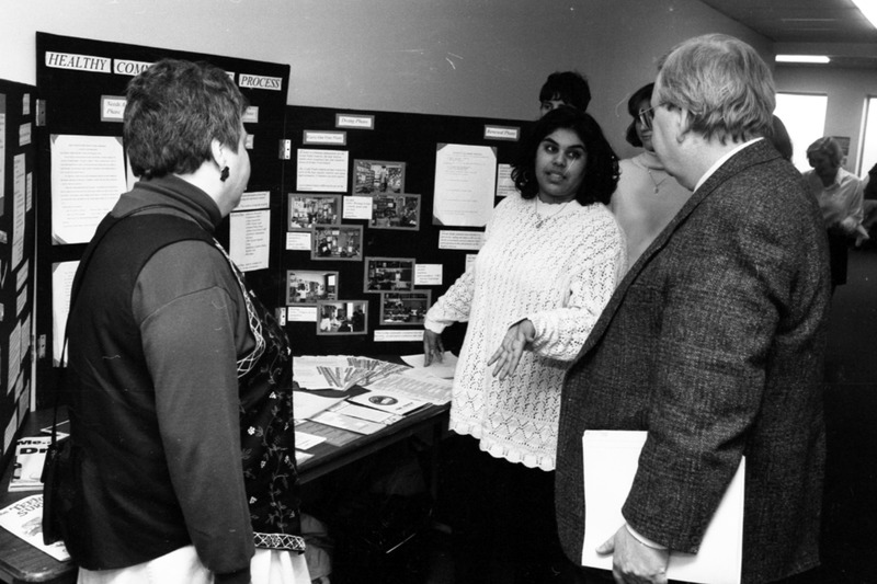 Image of fourth year nursing student Tamizan Vally presenting her project on community nursing to Dr. Brian Hennen, Chair of the Department of Family Medicine, and Judy Arnett, a public health nurse, at University Hospital.
